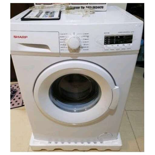 a white washing machine sitting on top of a white washing machine.
