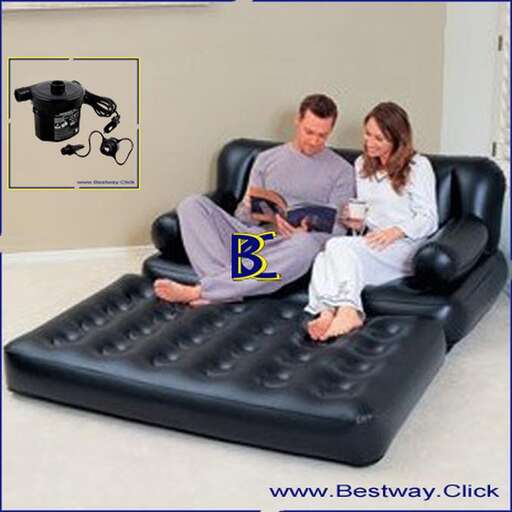 a black leather couch with a couple sitting on it.