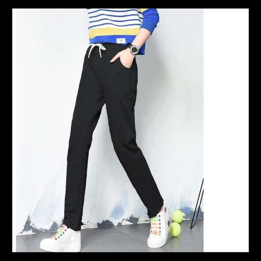 a model wears a striped shirt and trousers from the collection.