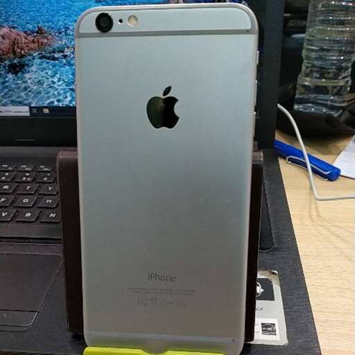 a cell phone sitting on top of a laptop.