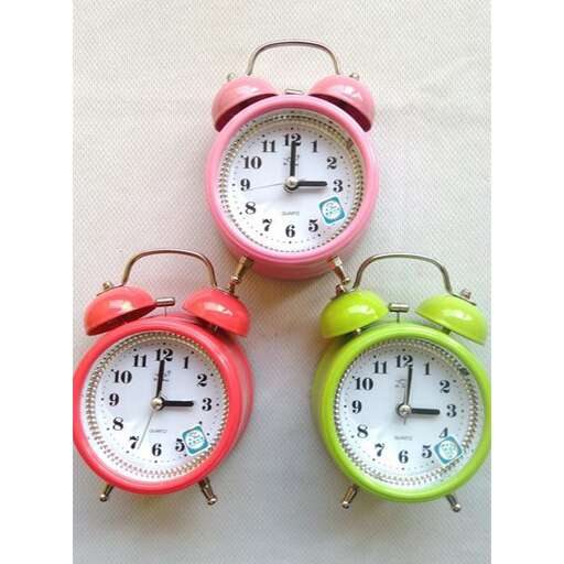 a colorful clock with a green and pink face.