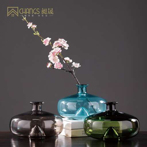 a vase with flowers on it and three other vases.
