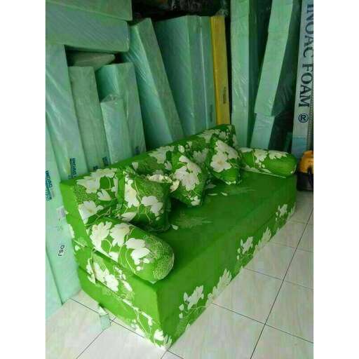 a bed made out of green fabric