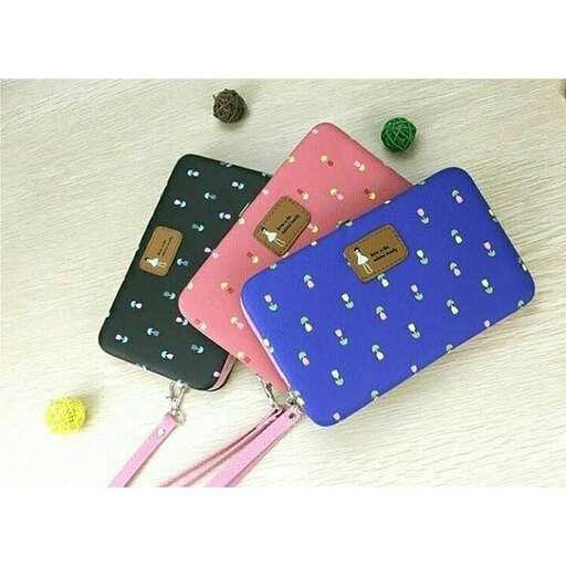 a pair of purses with pink handles on a white table.