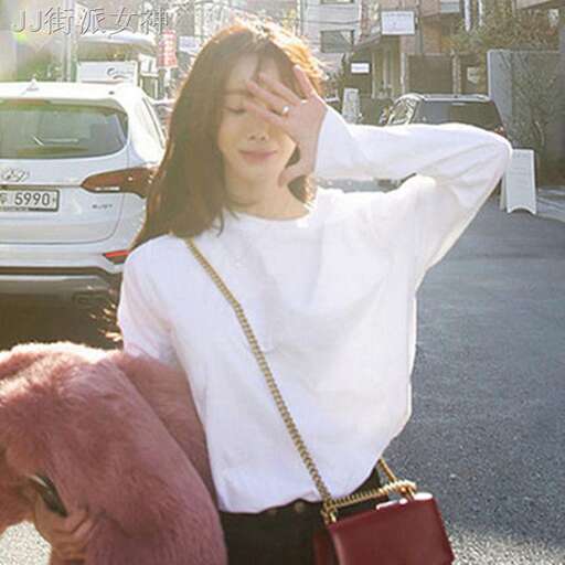 a woman holding a pink teddy bear and posing for a picture.