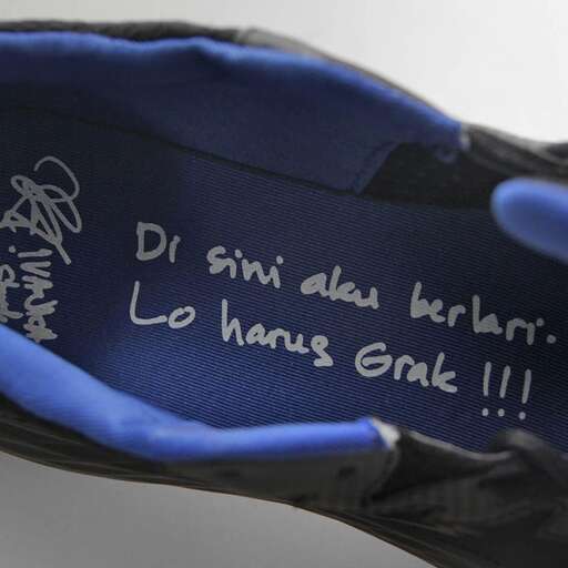 a pair of gloves with a message written on them.