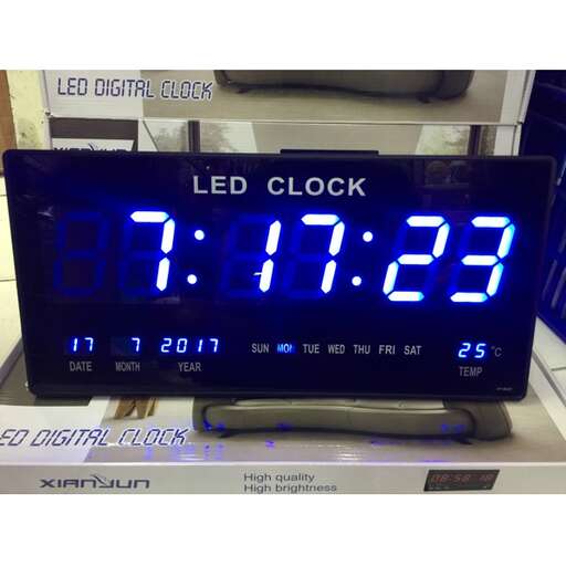 a digital clock with led lights on and a digital clock.