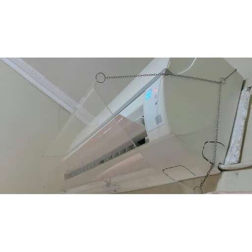 a computer monitor sitting on top of a white wall.