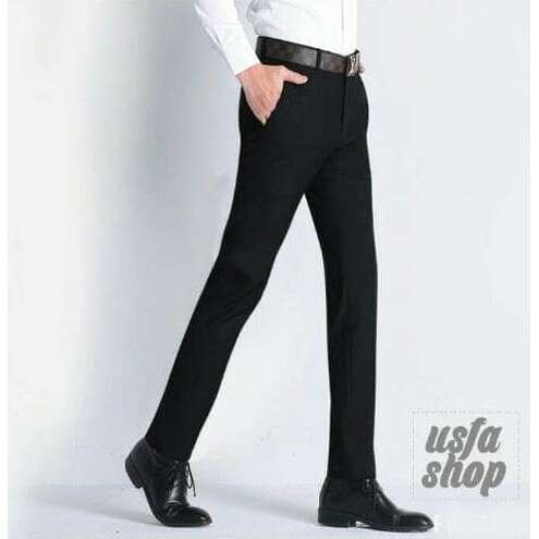 a man in a black suit and tie.