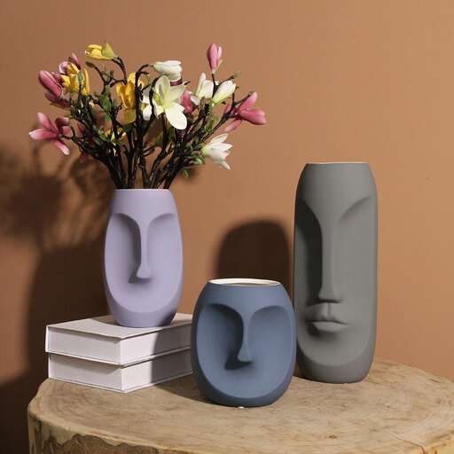 a vase with flowers in it on a table.