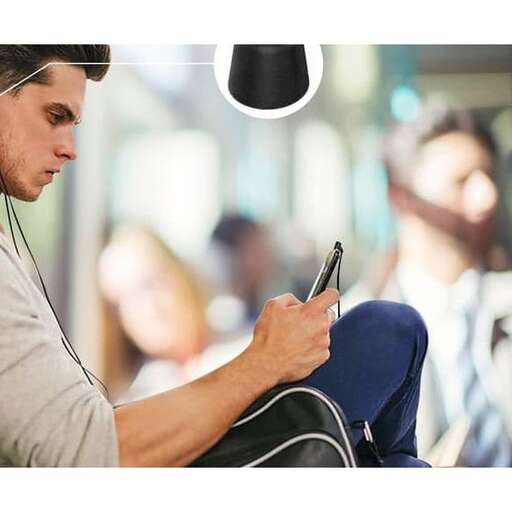 a man sitting on a couch with a cell phone.
