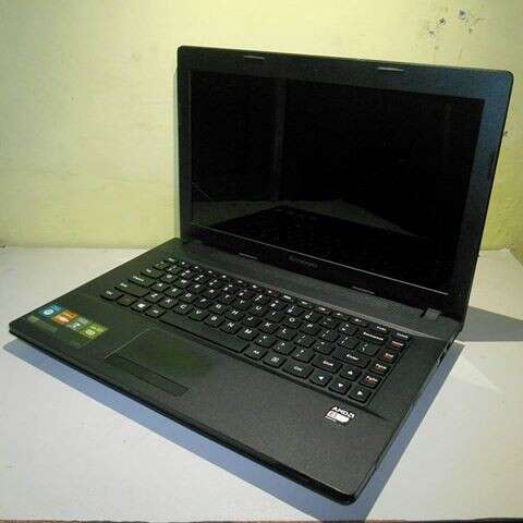 a black laptop computer sitting on a white table.