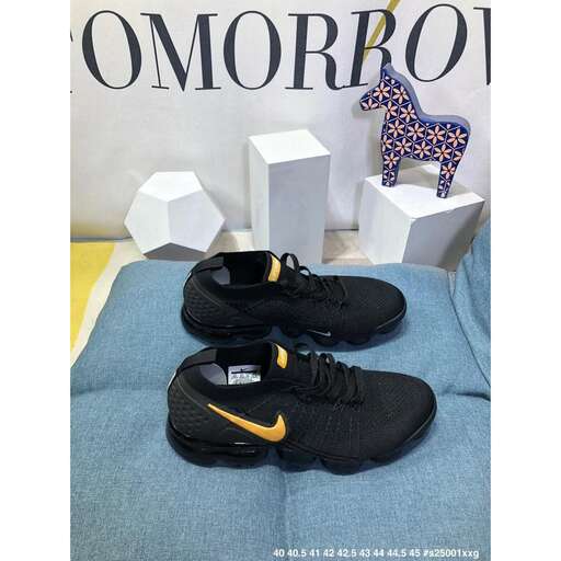 a pair of black sneakers sitting on top of a blue towel.