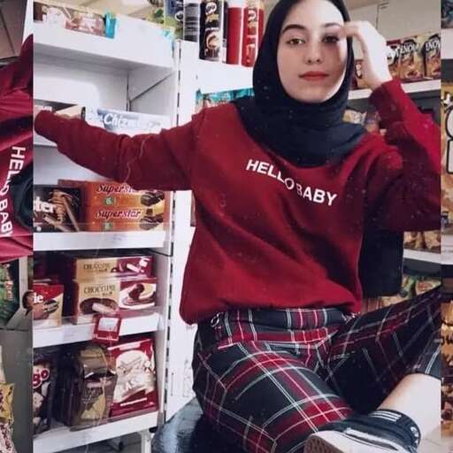 a woman sitting on a chair in front of a refrigerator.