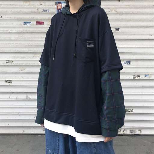 person is wearing a hoodie and jeans from the collection.