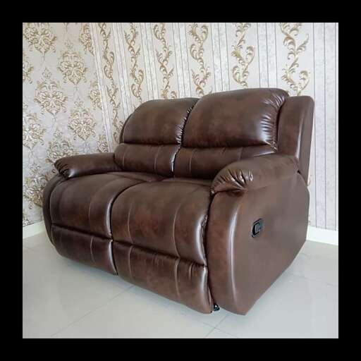 a brown leather couch sitting on a white floor.