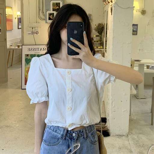 a woman taking a picture of herself with her phone.
