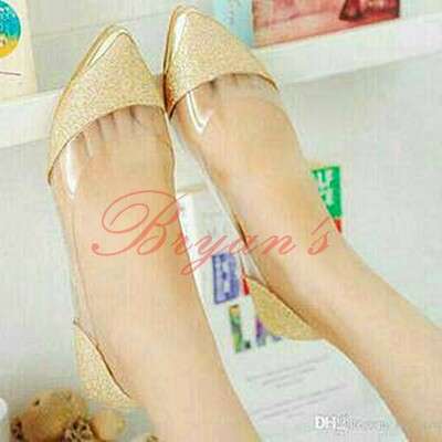 a pair of gold shoes with a cute little bear.