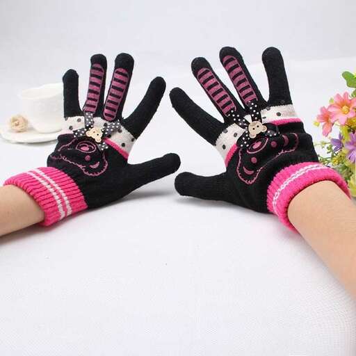 a person wearing gloves with a cat face on them.