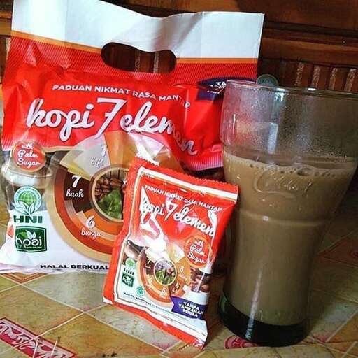 a coffee drink and a bag of food on a table.