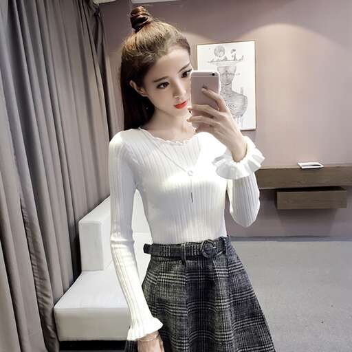 a girl in a skirt and a white shirt.