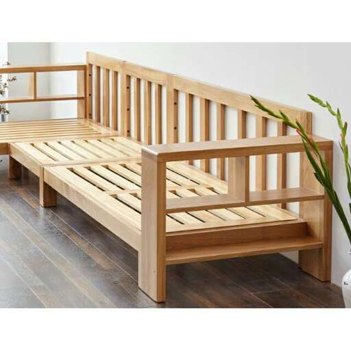 a large wooden bench with a plant in the middle.
