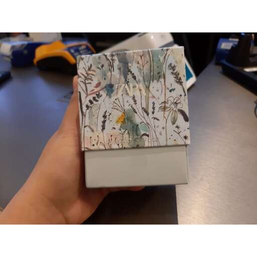 a handmade box with a bird in it.