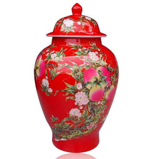 a red vase with a floral pattern