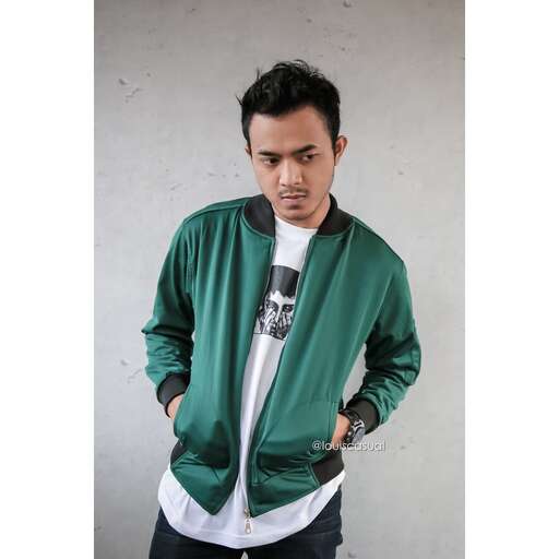 person poses for a photo in his green jacket.