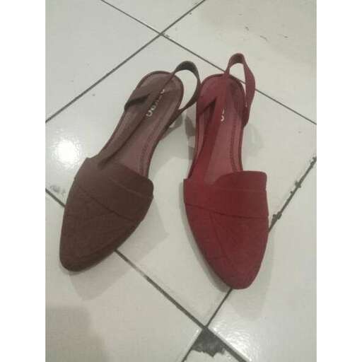 a pair of red shoes with a flat heel.