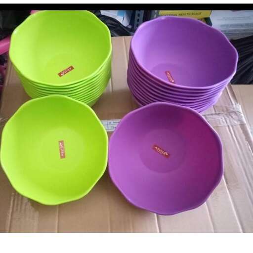 a stack of colorful bowls on a cardboard box.