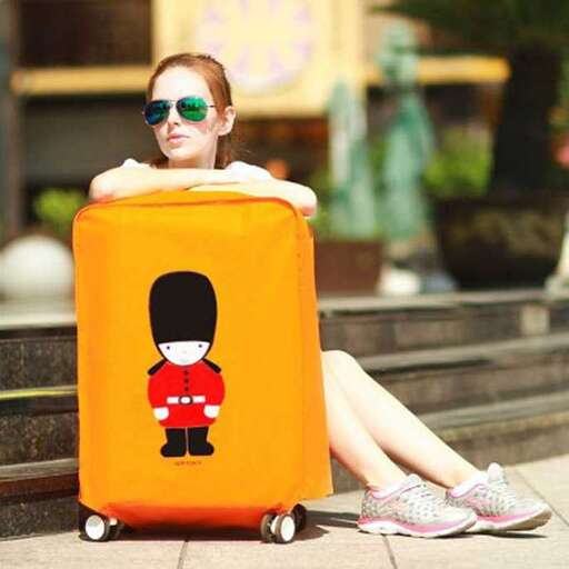 a girl sitting on a suitcase with a picture of a man in a hat.