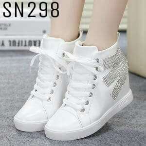 a woman's white tennis shoes with a white laces