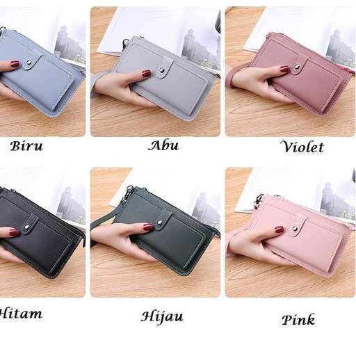 a person holding a small laptop computer with a pink case.