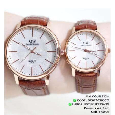 a pair of watches with a brown leather strap.