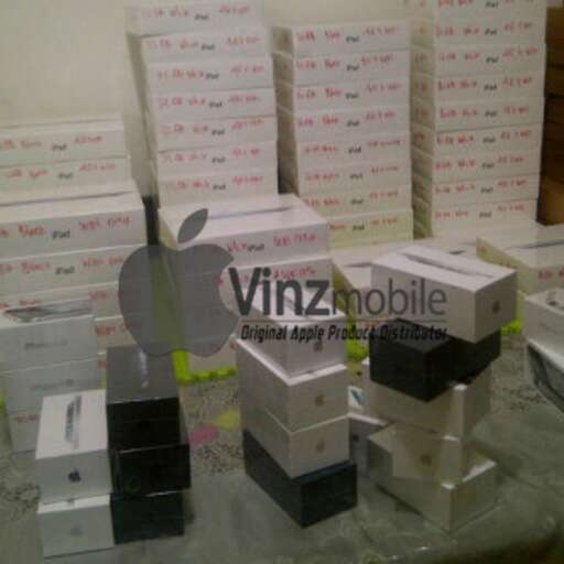 boxes of apple products are stacked on a table.