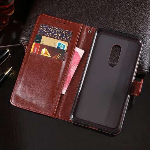 a black iphone case sitting on a leather seat.
