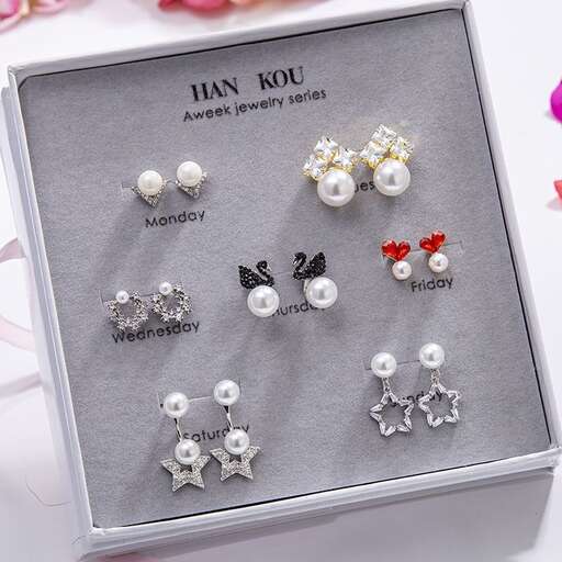 a set of earrings in silver and white