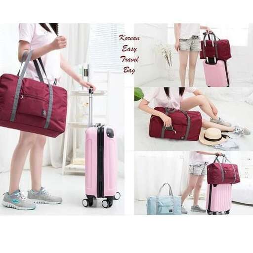 a woman is holding a suitcase and a bag.