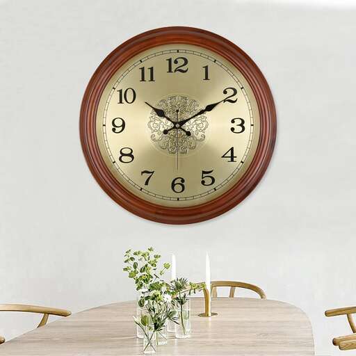 a clock on a wall with a plant in the center.
