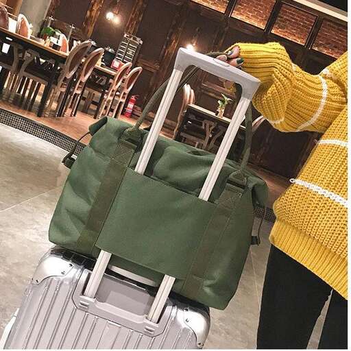 a person standing next to a suitcase in a room.