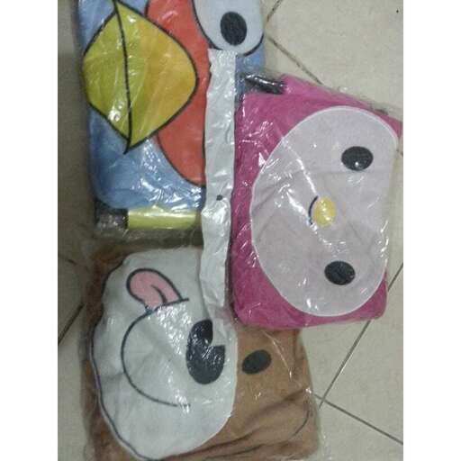two bags of stuffed animals sitting on the floor.