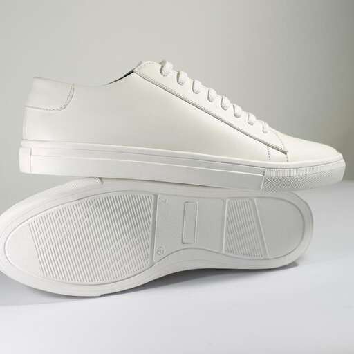a pair of white sneakers with a white sole.