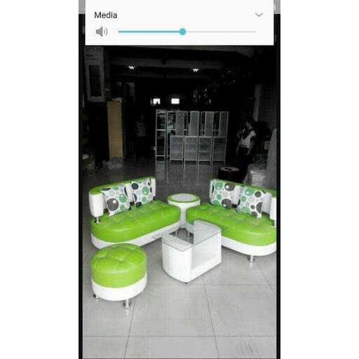 a green and white chair sitting in a room.