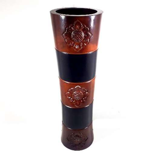 a brown and black vase with a floral design on it.