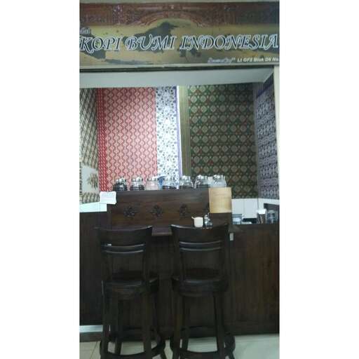 a restaurant with two wooden chairs and a counter.