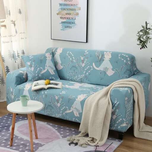 a living room with a couch, table and a rug.