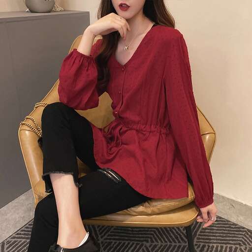person in a red sweater and black pants