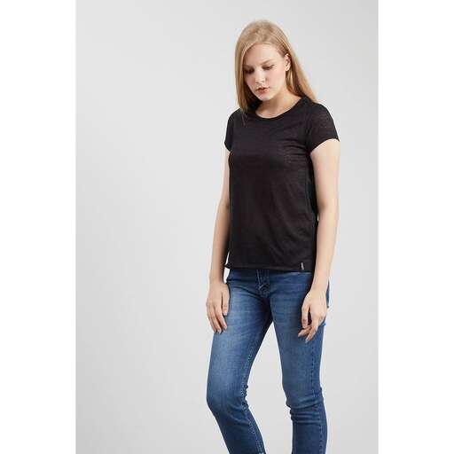 a model in a black t - shirt and jeans.