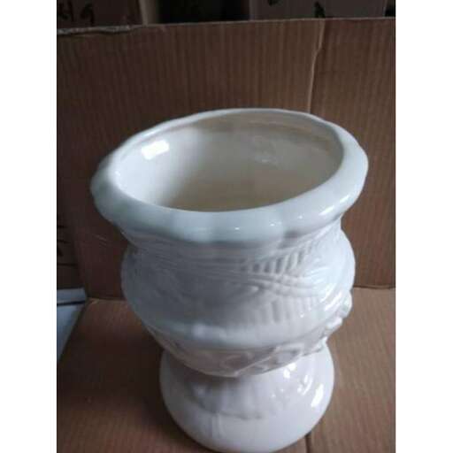 a white toilet with a bowl on the side of it.